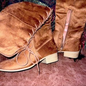 Dark brown thigh high boots with lace all the way up the back and a small zipper